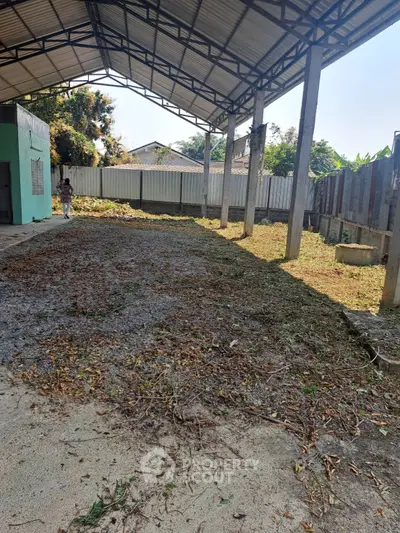 Spacious covered outdoor area with potential for development, featuring a sturdy metal roof and open sides.