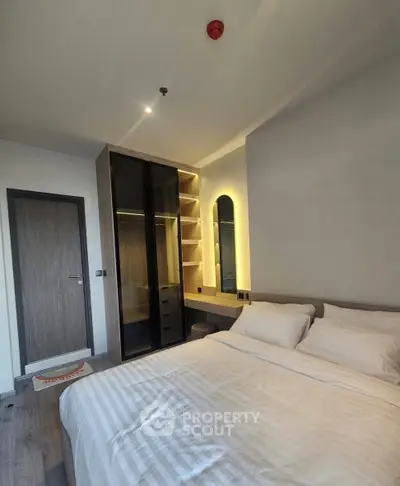 Modern bedroom with stylish walk-in closet and cozy lighting