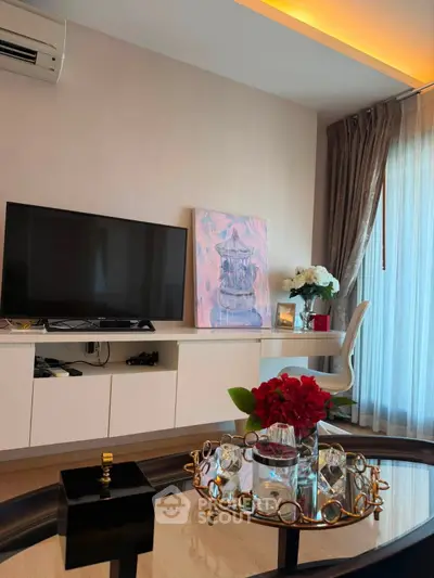 Stylish living room with modern decor, TV, and elegant furnishings in a bright, airy space.