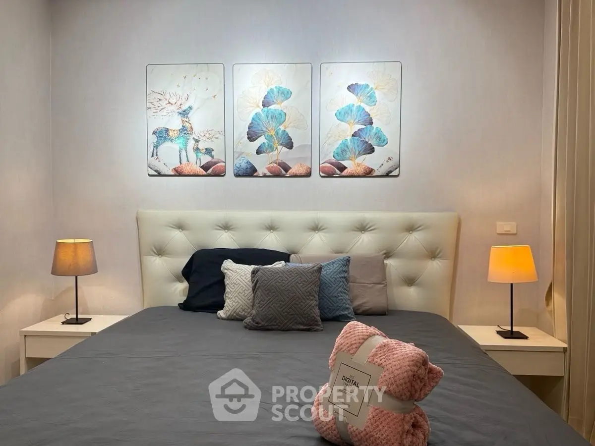 Cozy bedroom with elegant decor and soft lighting, featuring a plush bed and stylish artwork.