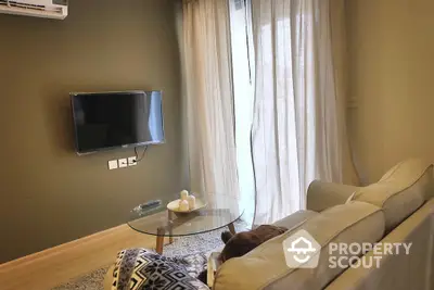 Cozy living room with modern decor and wall-mounted TV, perfect for relaxation.