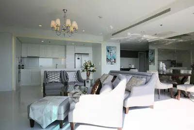Luxurious open-plan living room with elegant decor and modern kitchen