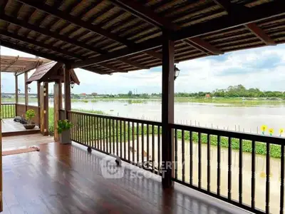 Stunning riverside balcony with wooden flooring and scenic views.