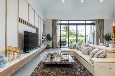 Luxurious living room with elegant decor and large windows offering a stunning garden view.