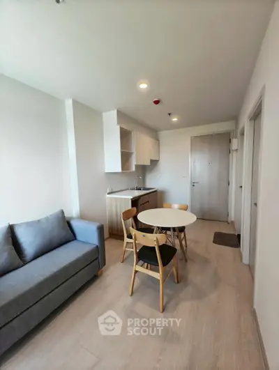 Modern living room with cozy sofa and dining area in open layout apartment