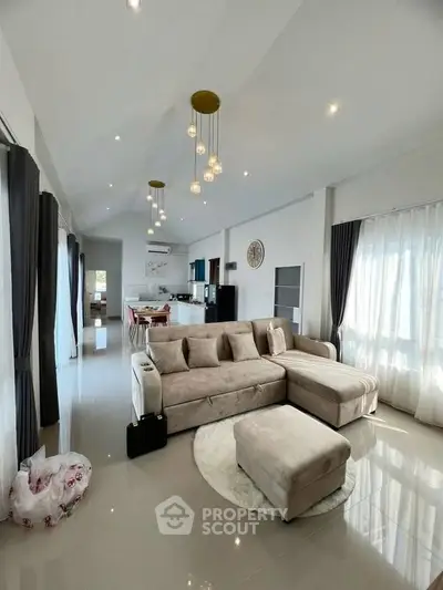 Spacious modern living room with elegant decor and open kitchen layout