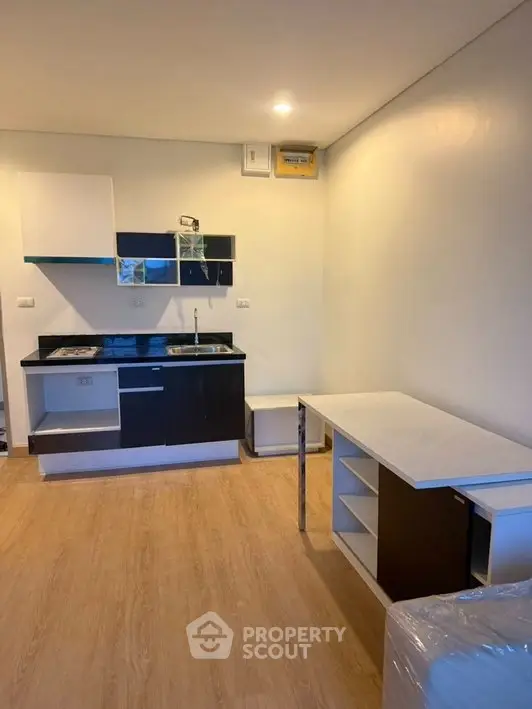 Modern compact kitchen with sleek cabinetry and open layout in a cozy apartment.