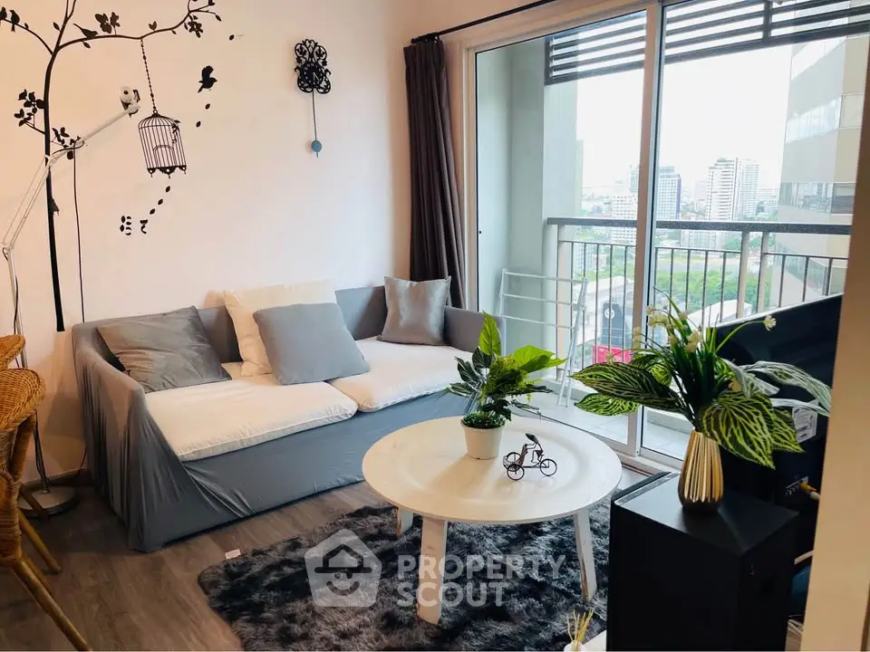 Chic living room with cozy sofa and city-view balcony, perfect for urban relaxation.