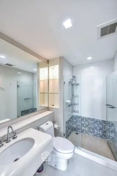 Modern bathroom with elegant glass shower and stylish tile accents