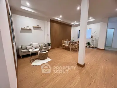 Spacious modern living room with elegant wooden flooring and stylish furniture