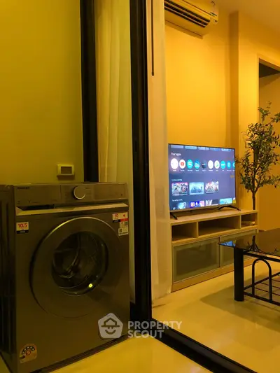 Modern apartment interior with washing machine and smart TV setup