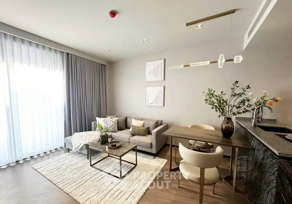 Modern living room with elegant decor, featuring a cozy sofa, stylish dining area, and natural light from large windows.