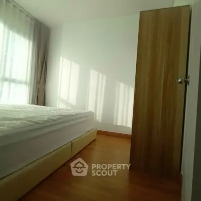 Bright and cozy bedroom with wooden flooring and natural light