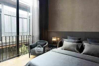 Luxurious bedroom with modern decor and large window overlooking balcony