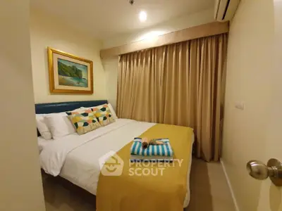 Cozy bedroom with stylish decor and warm lighting, perfect for relaxation.