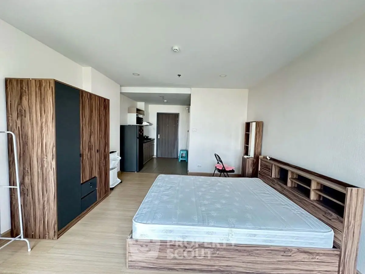 Spacious studio apartment with modern furnishings and open kitchen layout