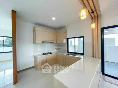 Modern kitchen with sleek design and ample natural light