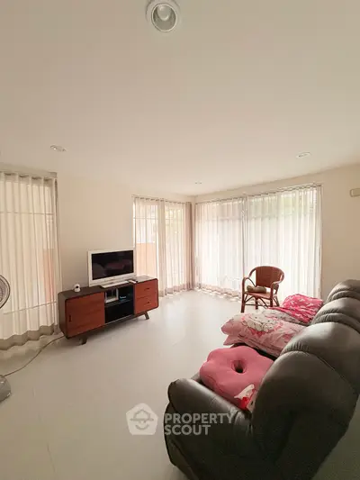 Spacious living room with natural light and modern furnishings