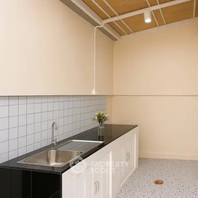 Modern kitchen with sleek black countertop and minimalist design