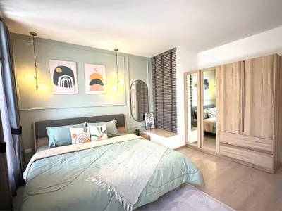 Stylish modern bedroom with elegant decor and ample natural light