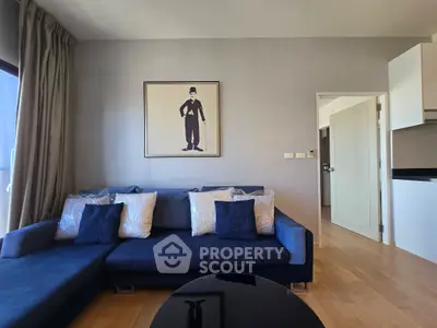 Modern living room with stylish decor and comfortable blue sofa in a contemporary apartment.