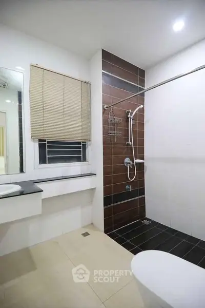 Modern bathroom with sleek design and walk-in shower in a contemporary home.