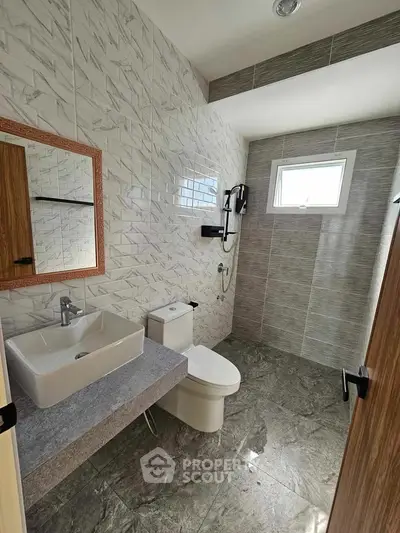 Modern bathroom with stylish tiles and natural light