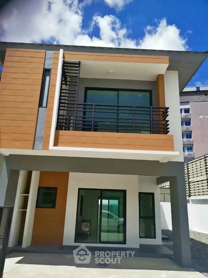 Modern two-story house with sleek design and balcony, perfect for contemporary living.