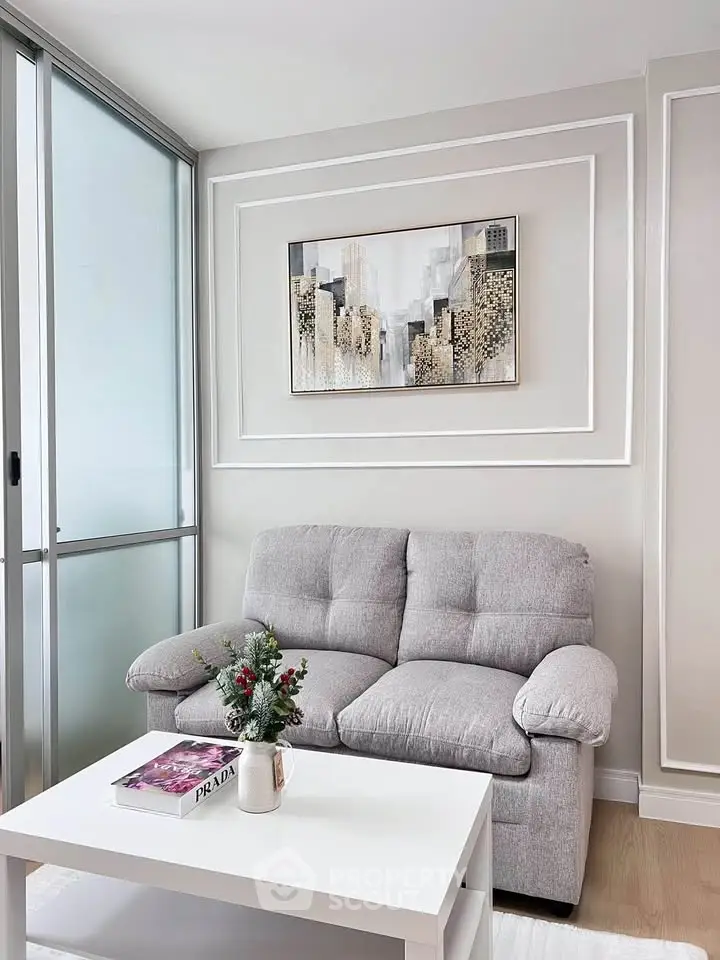 Modern living room with cozy gray sofa and stylish wall art, perfect for relaxation.