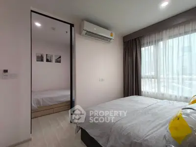 Modern bedroom with large window and air conditioning unit