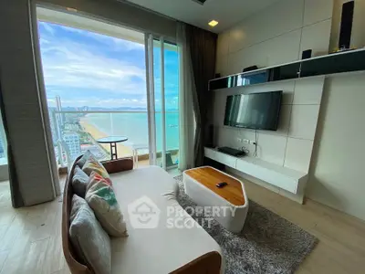 Luxurious living room with stunning ocean view and modern decor in high-rise apartment.