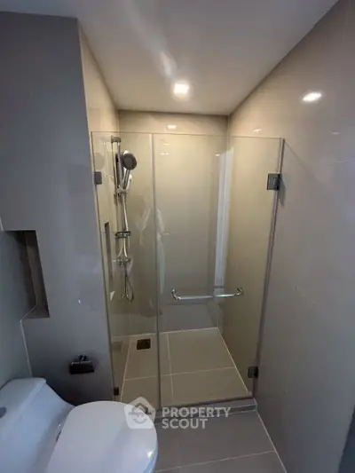 Modern bathroom with glass shower enclosure and sleek fixtures