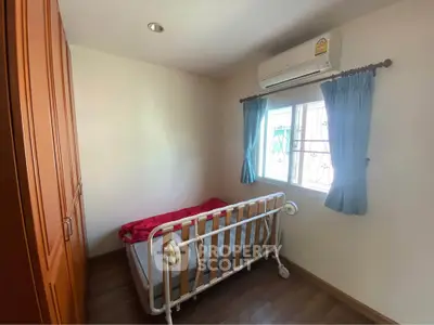 Cozy small bedroom with single bed and air conditioning