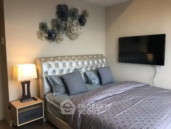 Luxurious bedroom with elegant decor and wall-mounted TV