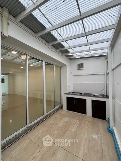 Spacious open kitchen with sliding glass doors and modern fixtures