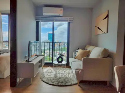 Modern living room with city view, cozy seating, and stylish decor in high-rise apartment.