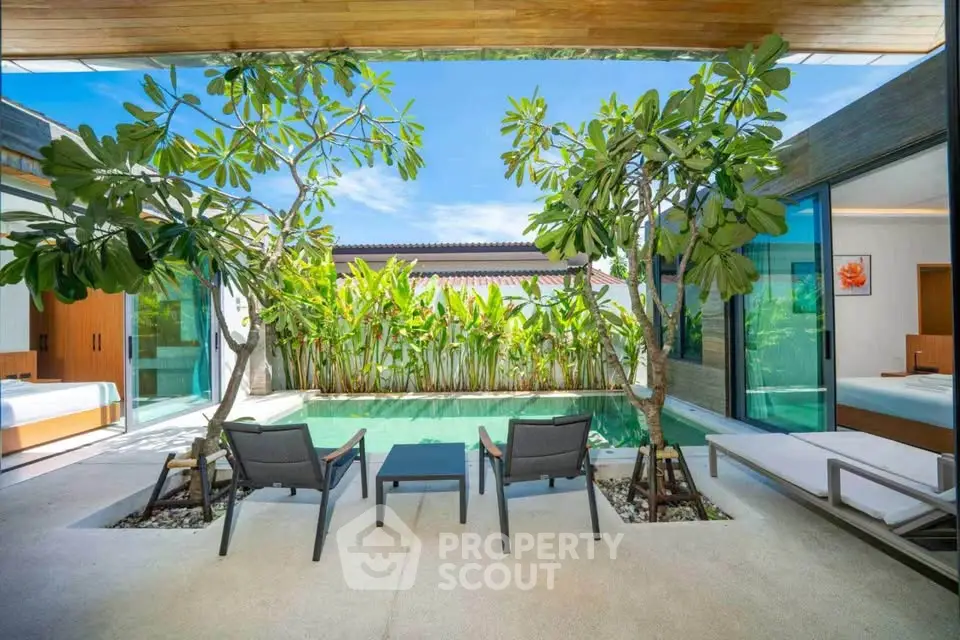 Luxurious villa with private pool and lush garden view, perfect for relaxation and tropical living.