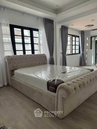 Luxurious bedroom with elegant bed and large windows in modern home