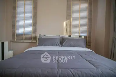 Cozy bedroom with modern decor and soft lighting, perfect for relaxation.