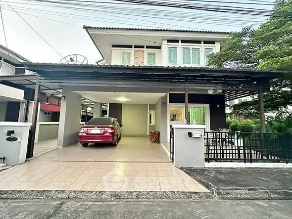 Spacious two-story house with carport and modern exterior design in a suburban neighborhood.