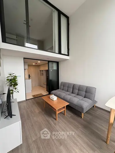 Modern loft apartment with stylish gray sofa and open layout