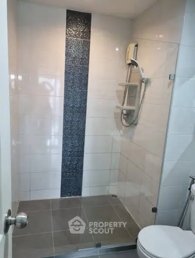 Modern bathroom with glass shower and sleek tile design