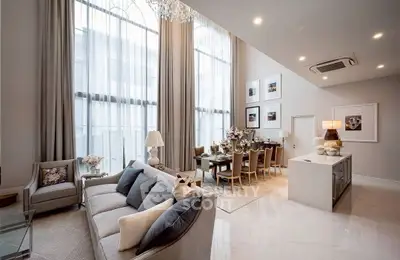 Luxurious high-ceiling living room with elegant dining area and modern decor