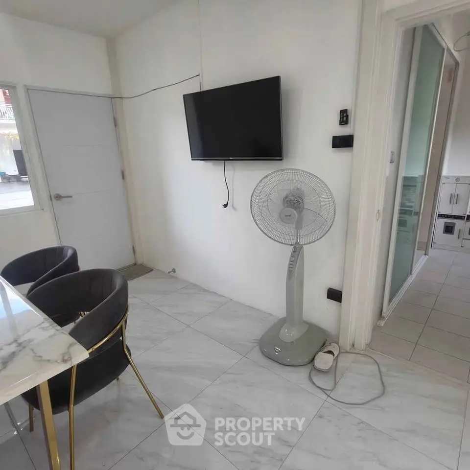 Modern living room with marble flooring and wall-mounted TV
