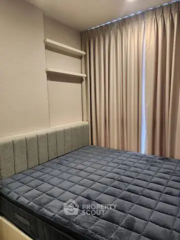 Cozy bedroom with modern decor and comfortable bed in a stylish apartment.