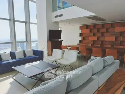 Luxurious modern living room with panoramic city views and stylish furniture.