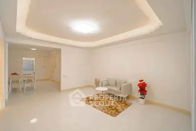 Spacious living room with modern decor and cozy seating area in a bright, open layout.