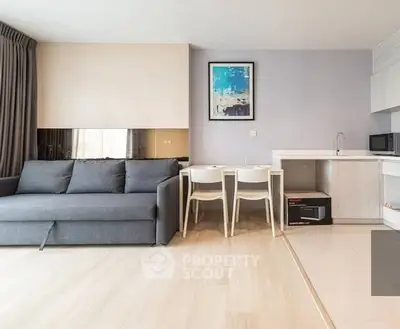 Modern living room with sleek furniture and compact kitchen area