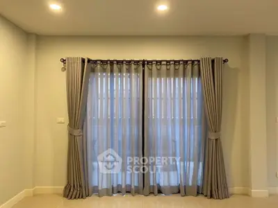 Elegant living room with stylish curtains and soft lighting, perfect for cozy evenings.