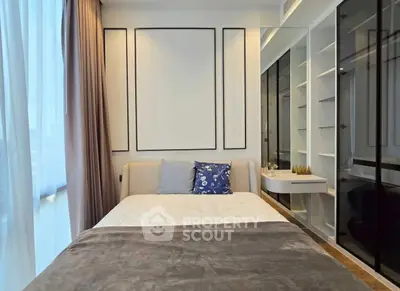 Modern bedroom with elegant decor and large window for natural light.